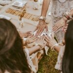 woman in white dress sitting on brown sand