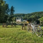 a bicycle parked next to a picnic table
