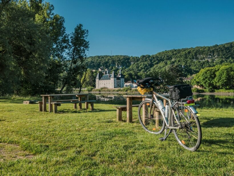 a bicycle parked next to a picnic table
