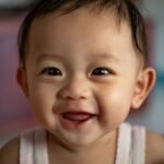 child in white tank top