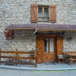 Stone building with wooden shutters and door
