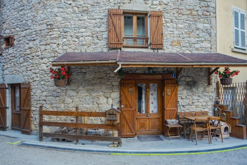 Stone building with wooden shutters and door