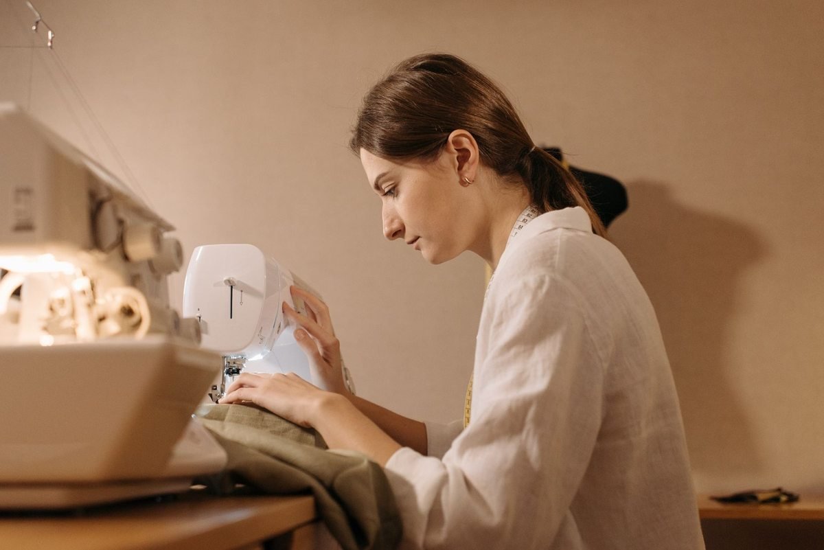 Femme utilisant une machine à coudre pour coudre un tissu